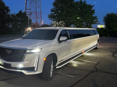 Side view of a white stretch limousine parked at night